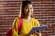 © WavebreakmediaMicro - Smiling asian female student using tablet