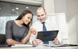 © Syda Productions - smiling businesspeople with tablet pc in office