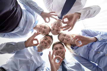 Wall Mural - smiling group of businesspeople standing in circle