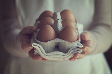 Mid Section Of A Woman Holding Box Of Eggs