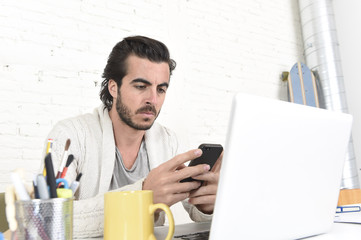 Wall Mural - attractive student or hipster style freelancer businessman working with laptop computer and mobile phone