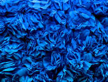 Background Of Blue Flowers Made Of Crepe Paper. Pleated Paper Decorations Closeup, Texture