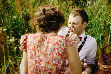 Wall Mural - beautiful happy bride and stylish retro groom lying on tweed bla