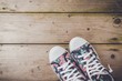 Colorful sneakers on wooden floor