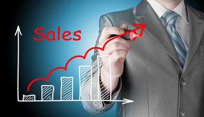 business man drawing graph of sales