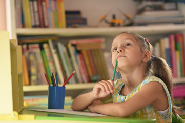 Wall Mural - little girl drawing at home
