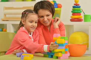 Wall Mural - little girl playing with mother