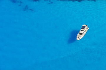 Wall Mural - Aerial view of single yacht in azure sea