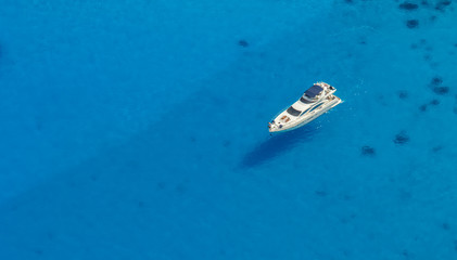 Wall Mural - Aerial view of single yacht in azure sea