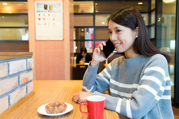 Poster - Woman talk to cellphone and enjoy her breakfast in coffee shop