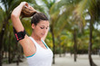 © Dirima - Fitness woman tying ponytail and getting ready for beach outdoor workout. Female athlete preparing for exercising.