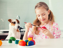 Girl With Dog Painting Eggs