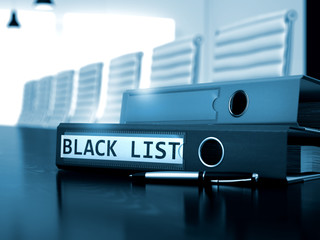 file folder with inscription black list on desktop. black list - business concept on blurred backgro
