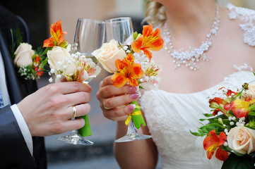 Wall Mural - Bride and groom are holding champagne glasses