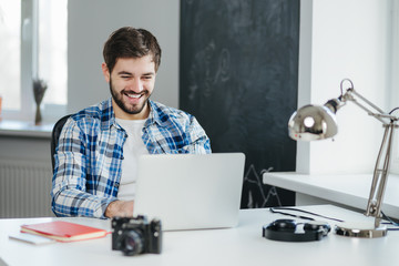 Handsome man having a video conversation on laptop