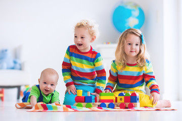 Wall Mural - Kids playing with wooden toy train