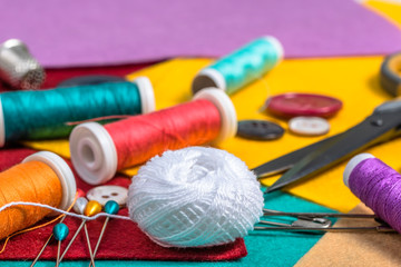 Various sewing accessories on a colored felt.