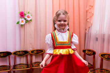 little girl in red Russian national dress