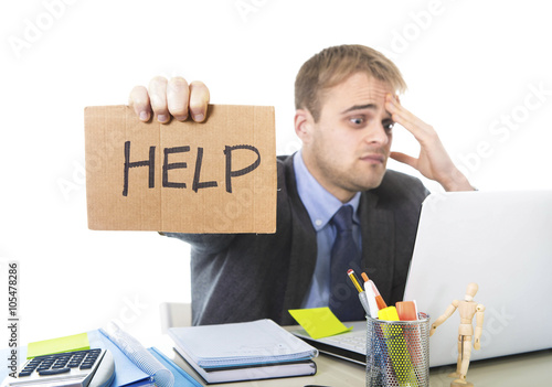 Fotografía young desperate businessman holding help sign looking worried suffering work str