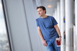 © Maria Sbytova - Male passenger holding passport and boarding pass at the airport