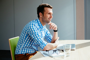 Wall Mural - Handsome man at office planning new ideas