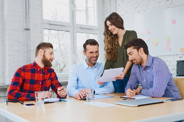 Wall Mural - Cheerful casual business partners working together in modern off