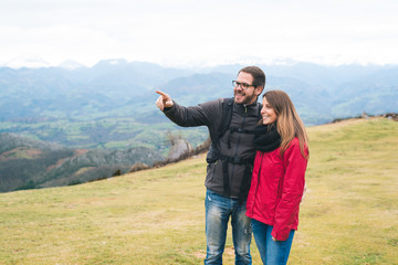 young couple in love hiking outdoor on vacation, enjoying relaxing rural holidays.