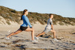 © Sergey Nivens - Young couple on beach training together