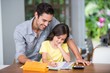 © WavebreakmediaMicro - Smiling father assisting daughter with homework