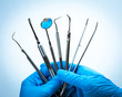 © fotofabrika - Dental tools in gloved hand