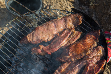 Closeup of grilled meat in the barbecue outdoors