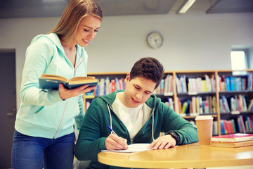 Wall Mural - happy students preparing to exams in library