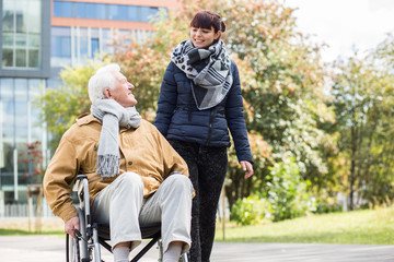 Wall Mural - Young woman helping disabled relative