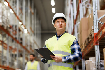 Wall Mural - man with clipboard in safety vest at warehouse