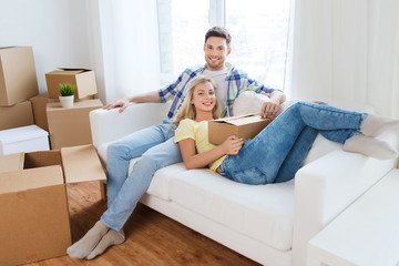 Poster - happy couple with big cardboard boxes at new home