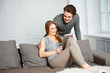 © below - Young couple watching photos on internet with tablet