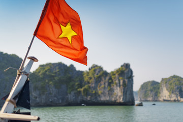 Wall Mural - The flag of Vietnam fluttering on ship. The Ha Long Bay