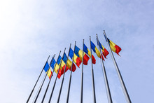 Romanian Flag Poles On Blue Sky, Bottom To Top View