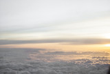 Fototapeta Niebo - High above the clouds with beautiful sunset light