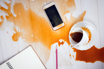 On office desk ,Coffee spilled on phone