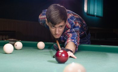 boy aiming for shot the billiard ball