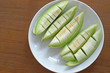 peel cantaloupe melon in white plate