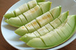 peel cantaloupe melon in white plate