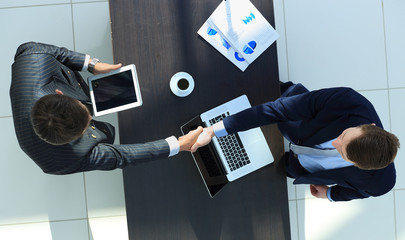 Wall Mural - Businessmen shaking hands. Top View