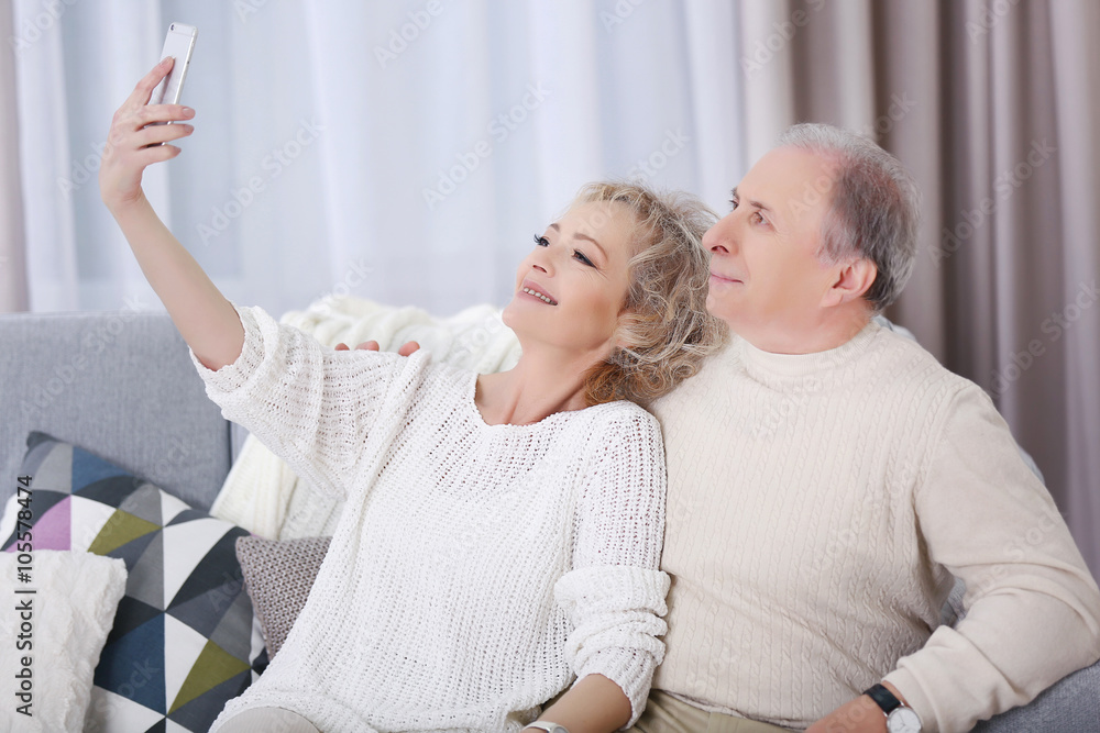 Happy mature couple taking photo of their self with mobile phone at ...
