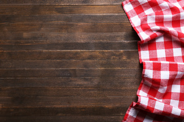 Wall Mural - Checkered napkin on wooden background