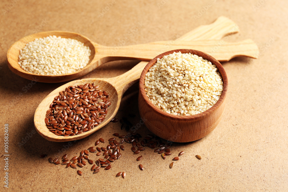 Sesame and flax seeds on beige background, closeup