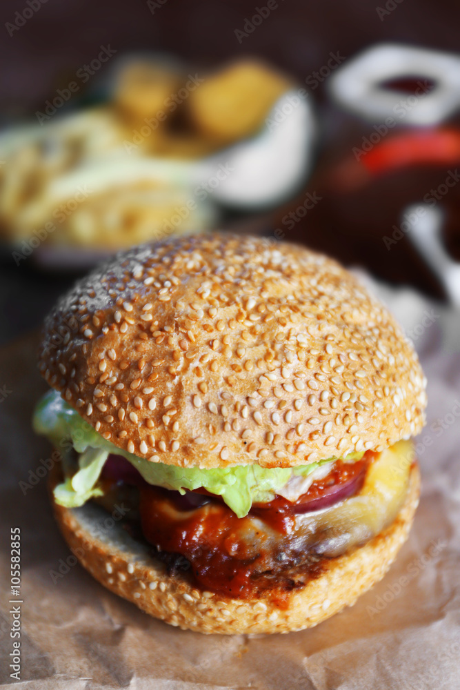 Big tasty hamburger on a paper, close up