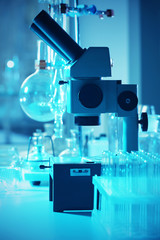 Wall Mural - microscope and different test tubes and flasks in laboratory