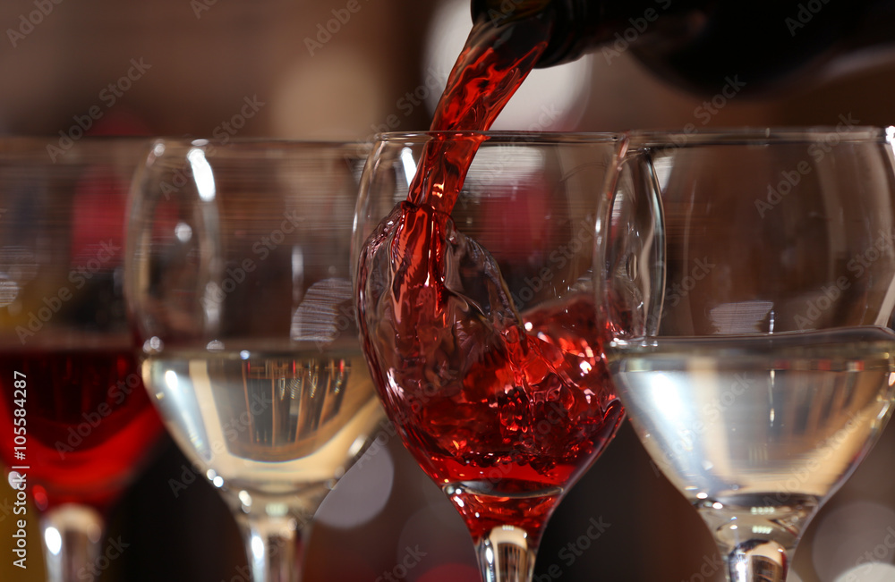 Red wine pouring into wine glass, closeup